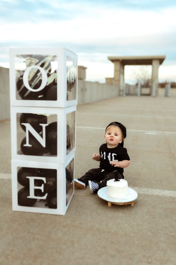 Unconventional one-year family photo session with a toddler on a skateboard by a well known family photographer near Kansas City