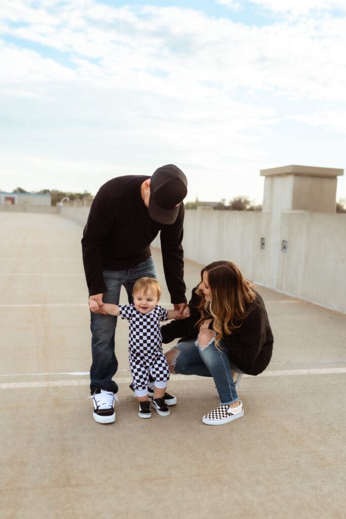 Candid lifestyle family photography of a one-year-old with a skateboard, photographed in Kansas City area