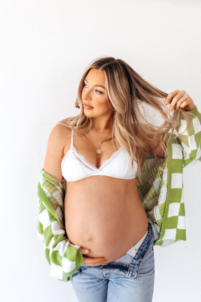 Casual studio maternity outfit with denim and color pops photographed in Kansas City, Missouri