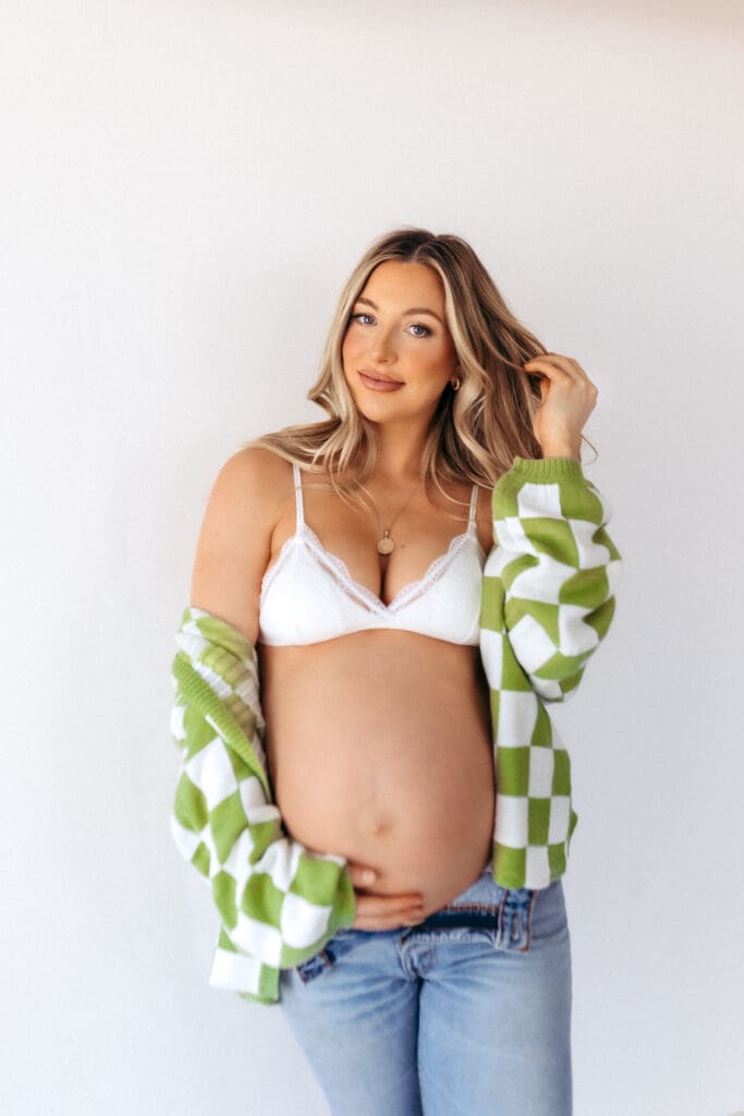 Pregnant women wearing a fitted bralette and jeans during a casual studio maternity session in Kansas City, MO