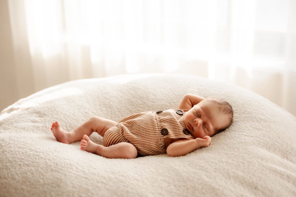 Studio newborn lifestyle session captured near Kearney Missouri featuring a sleeping baby.
