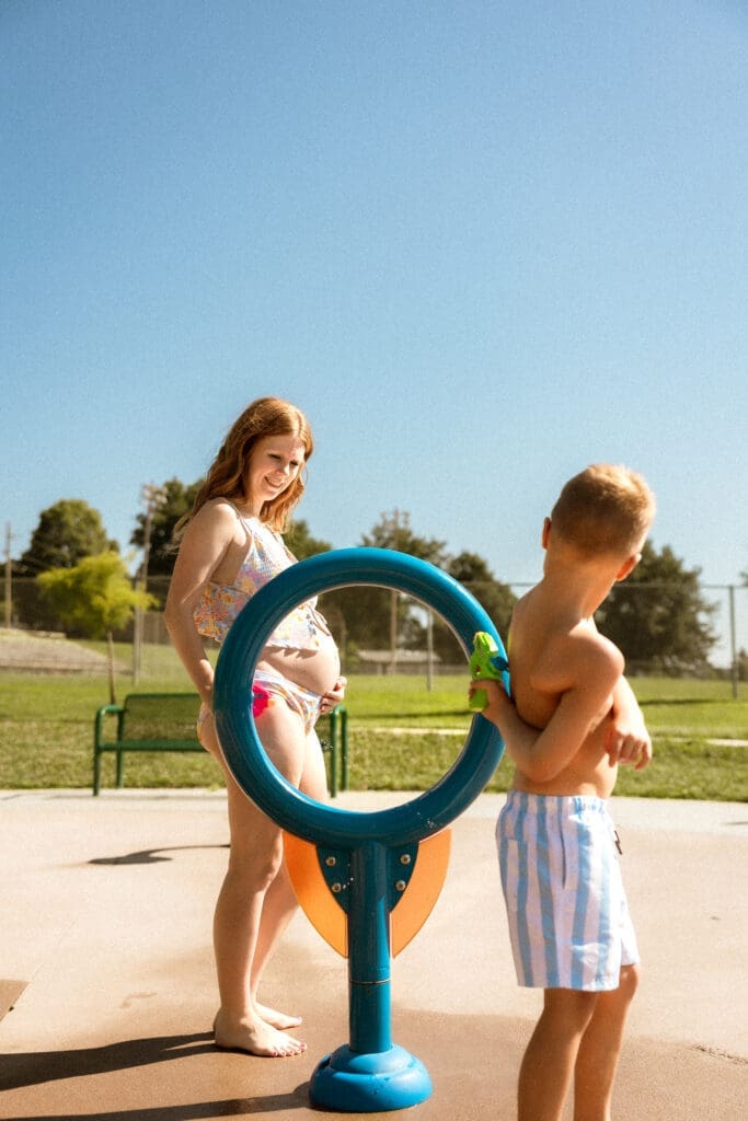 Son playing with his mom at the splash pad in Liberty Missouri. 