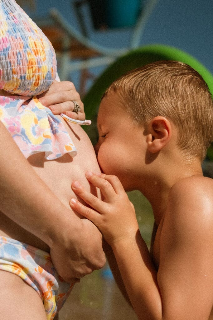 Summer maternity photos at a splash pad near Kansas City area. 